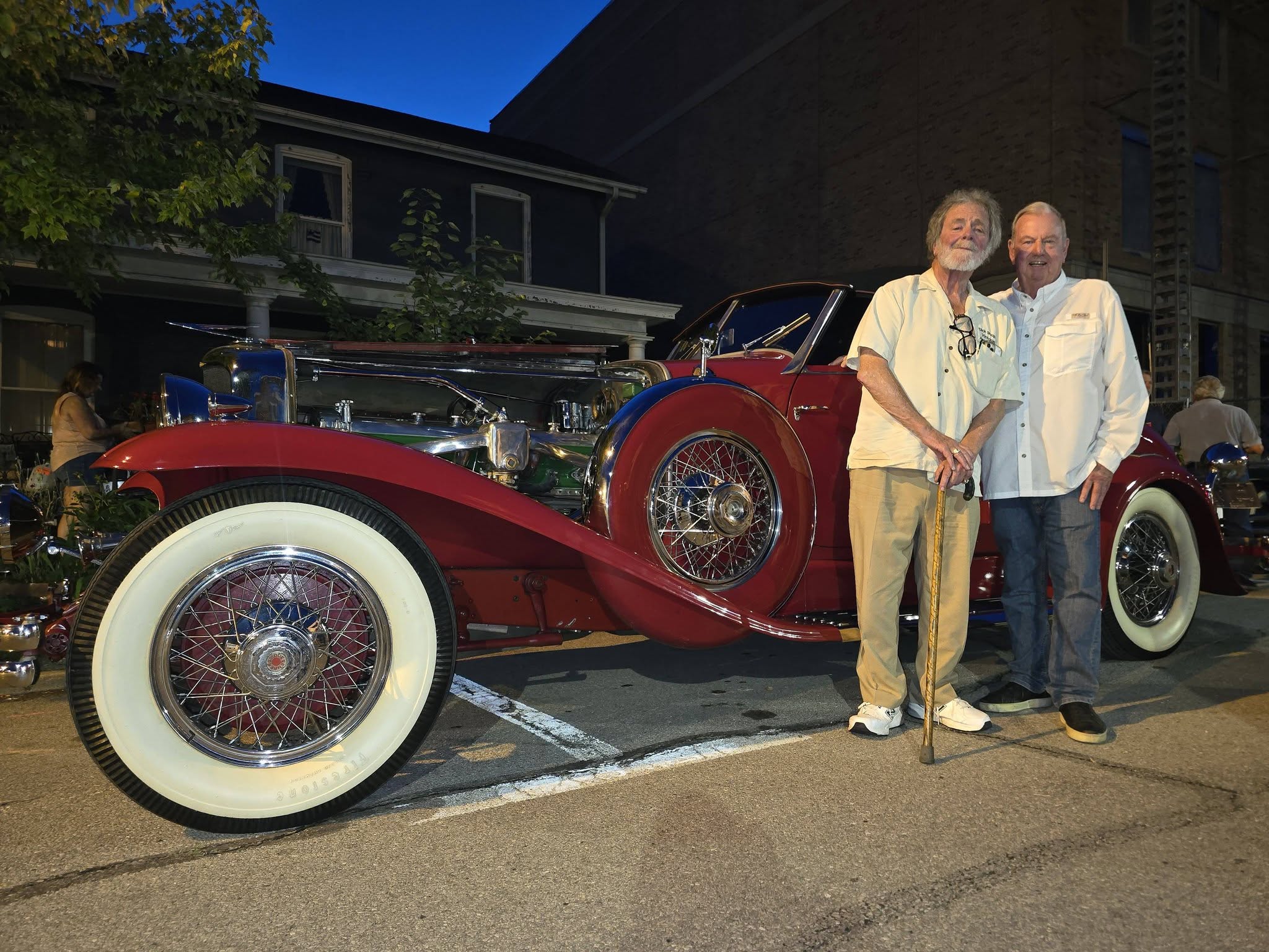 Dick Shappy and Richie Clyne pose with Shappy's 1929 Duesenberg Model J-268 Convertible Coupe on 9th 
          Street at the 2026 Auburn Cord Duesenberg Festival in Auburn, Indiana.